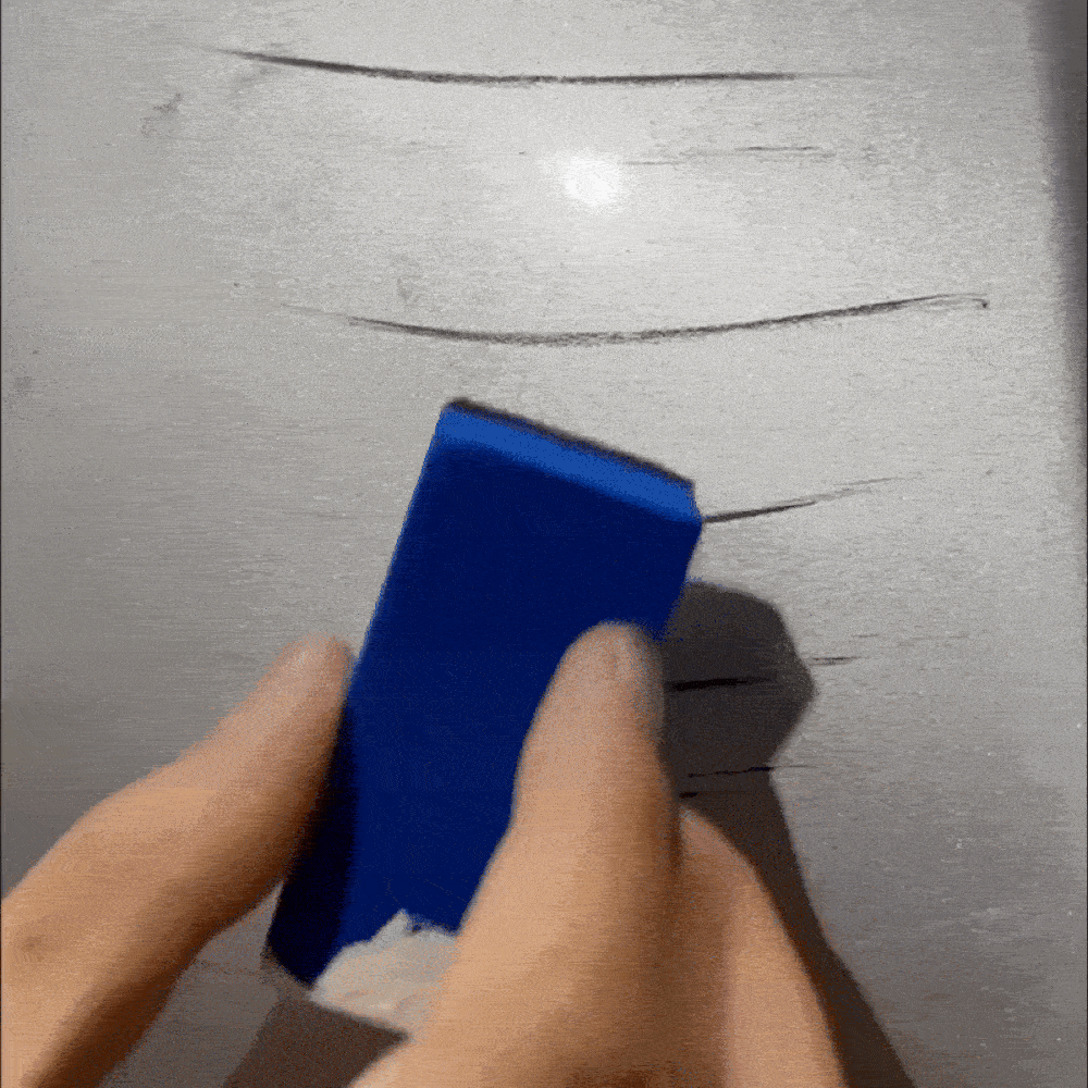 Demonstration of Optimo™ PRO Scratch Eraser on car bodywork - the product removes surface scratches and marks in seconds, leaving a smooth, shiny paint finish.